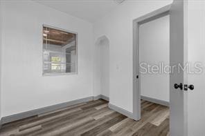 empty room with dark wood-type flooring