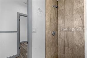 bathroom with a tile shower