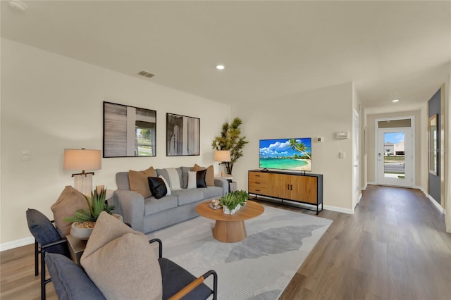 5879 Galloping Dr, Apopka, FL 32712 - living room with visible vents, baseboards, and wood finished floors