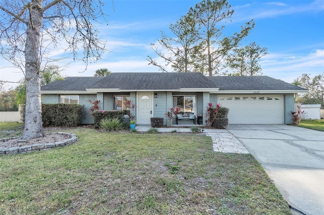 single story home featuring a garage and a front lawn