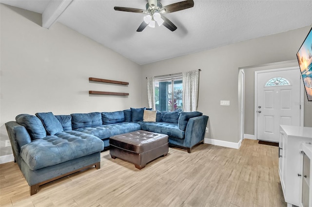 living room featuring a textured ceiling, light hardwood / wood-style flooring, lofted ceiling with beams, and ceiling fan