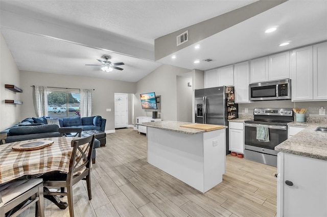 kitchen featuring white cabinetry, appliances with stainless steel finishes, and a center island