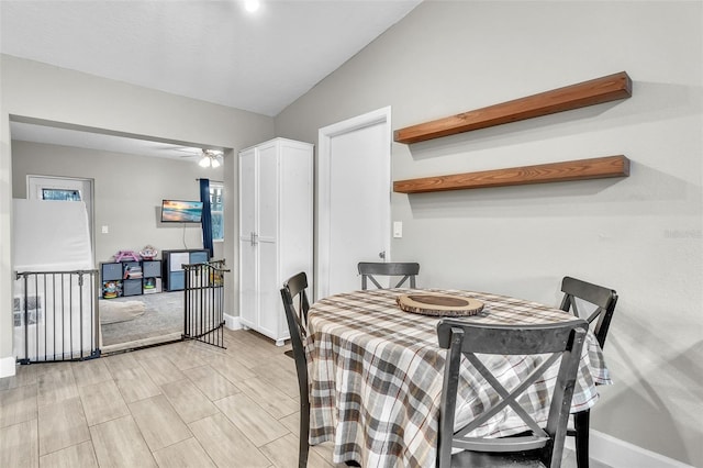 dining room featuring vaulted ceiling and ceiling fan