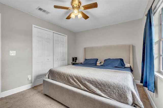 bedroom with light carpet, a closet, and ceiling fan