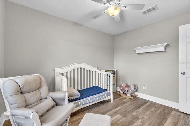 bedroom featuring hardwood / wood-style flooring and ceiling fan