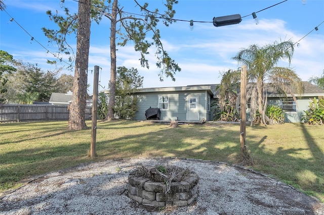 view of yard with an outdoor fire pit