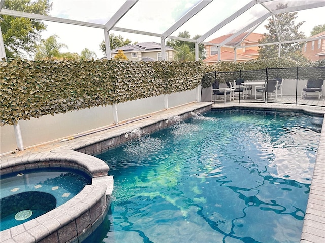 view of pool featuring an in ground hot tub, pool water feature, and a patio