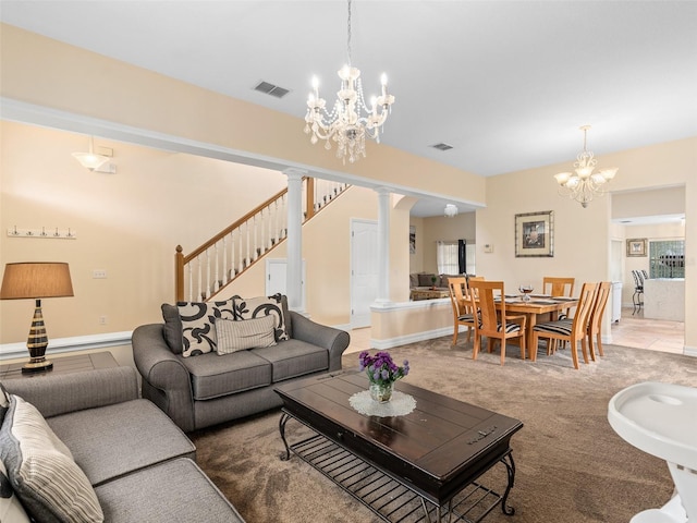 carpeted living room with an inviting chandelier, plenty of natural light, and decorative columns