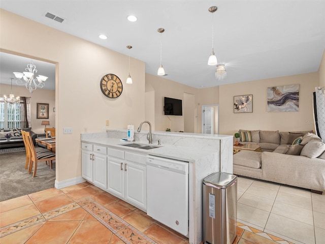 kitchen with dishwasher, sink, white cabinets, and decorative light fixtures