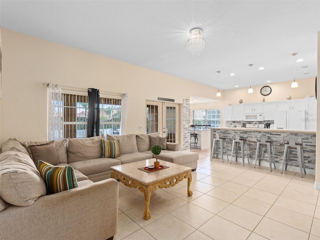 living room featuring light tile patterned floors and french doors