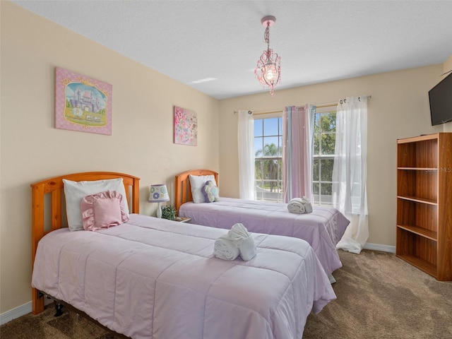 bedroom with carpet and a textured ceiling