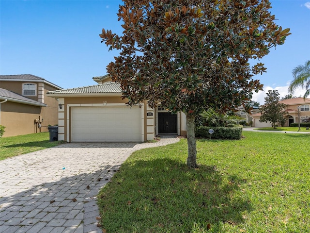 view of front of property with a garage and a front yard