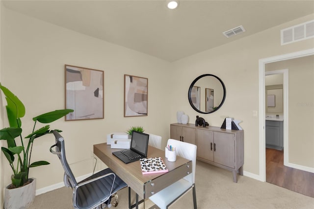 home office featuring light colored carpet