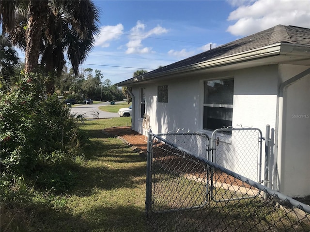 view of side of property with a yard