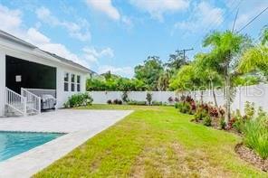 view of yard featuring a fenced in pool and a patio area