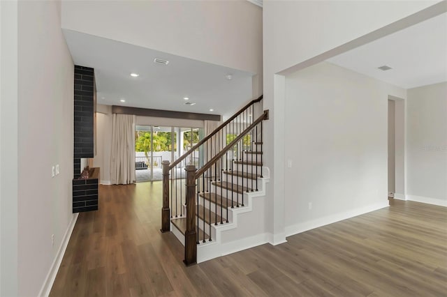 staircase featuring wood-type flooring