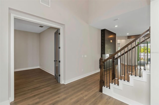 stairs featuring wood-type flooring