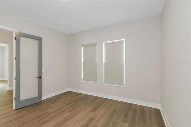 spare room featuring wood-type flooring