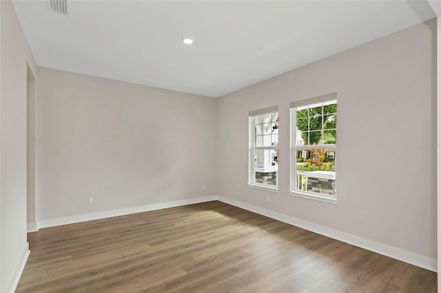 empty room with hardwood / wood-style flooring