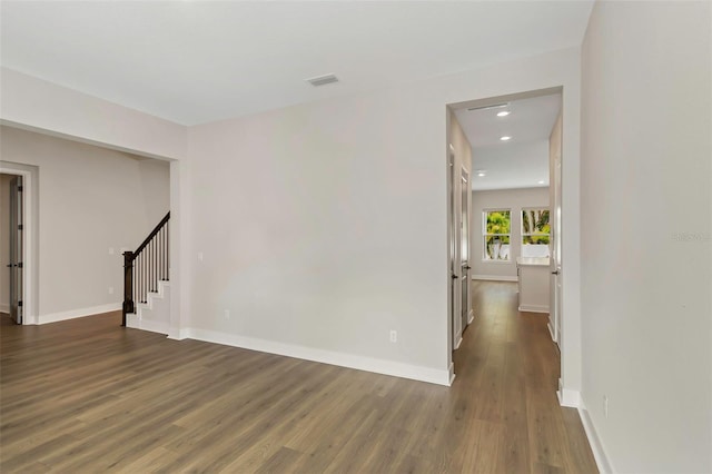 empty room featuring dark wood-type flooring