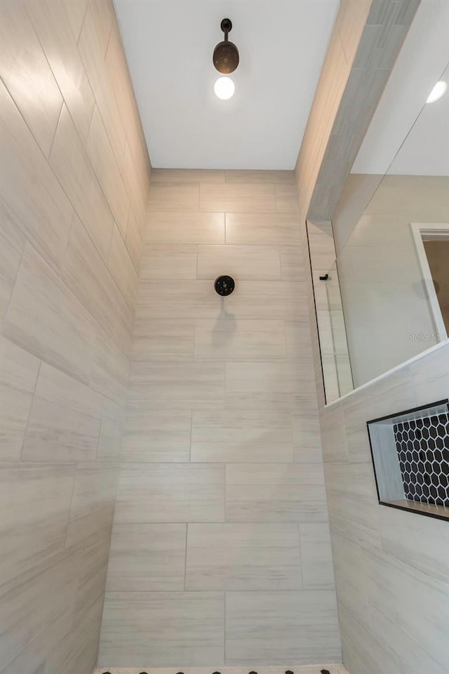 bathroom with a tile shower