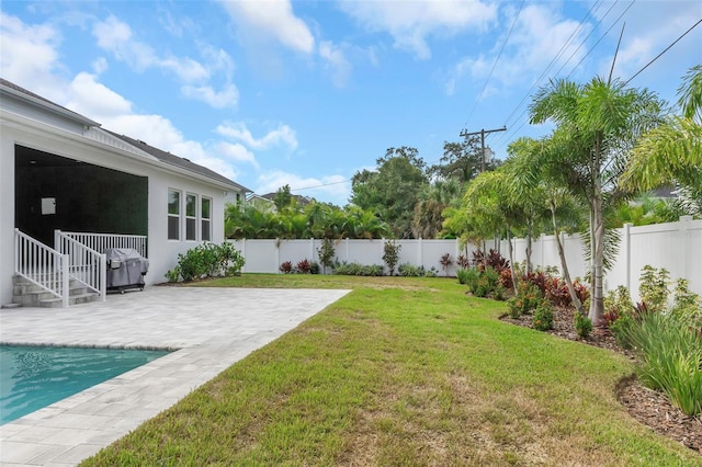 view of yard with a fenced in pool and a patio area