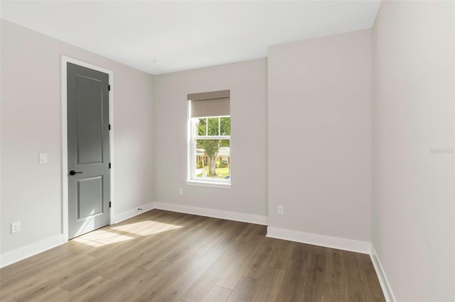 unfurnished room featuring hardwood / wood-style flooring