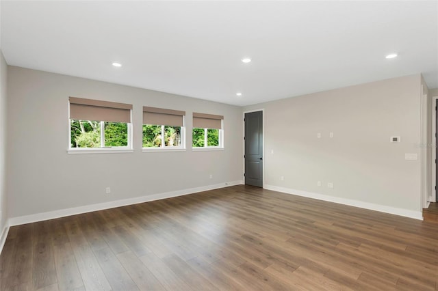 spare room with dark wood-type flooring