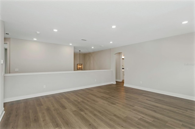 spare room featuring dark wood-type flooring