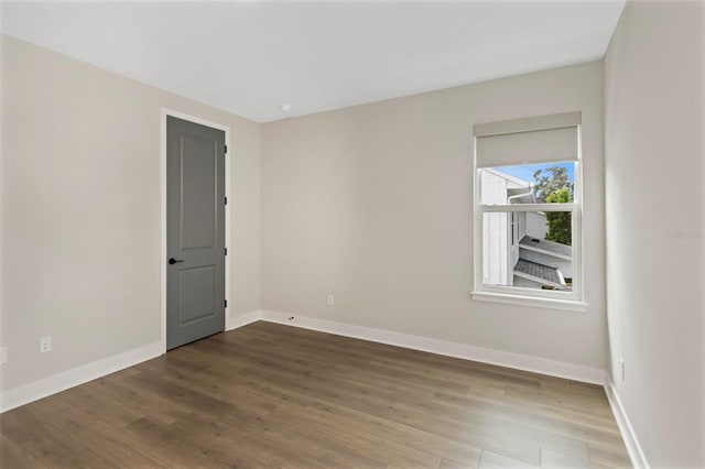 unfurnished room with hardwood / wood-style flooring