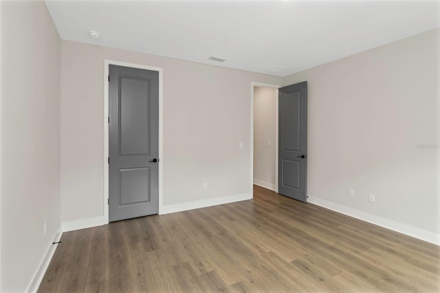 spare room with wood-type flooring