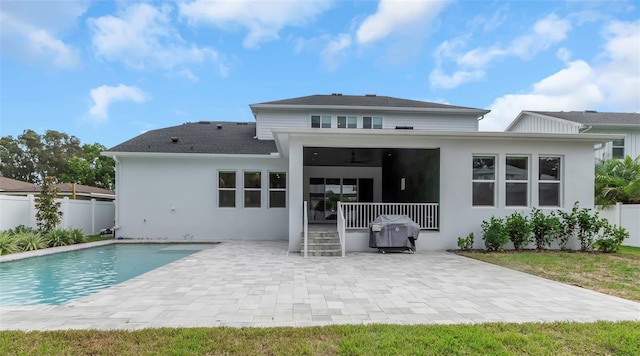 back of house featuring a fenced in pool, a patio, and ceiling fan