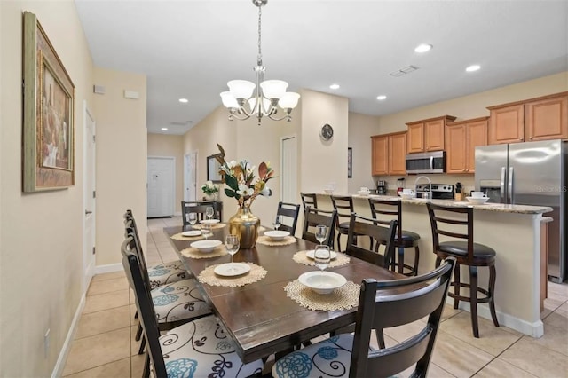 dining space with light tile patterned flooring and an inviting chandelier