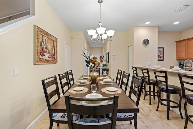 dining room featuring light tile patterned flooring, sink, and a notable chandelier