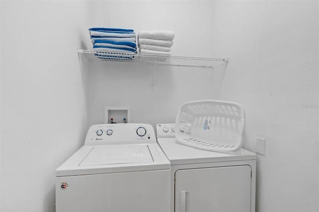 clothes washing area with washer and clothes dryer