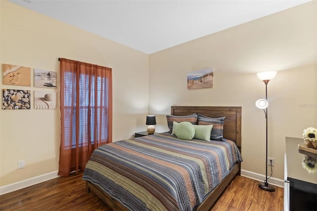 bedroom with dark hardwood / wood-style floors