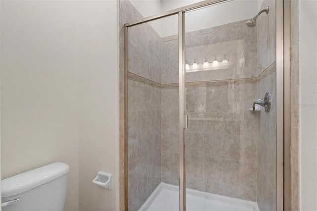 bathroom with toilet and walk in shower