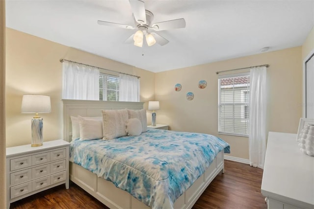 bedroom with multiple windows, dark wood-type flooring, and ceiling fan