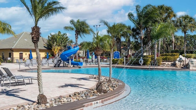 view of swimming pool featuring a patio and a water slide