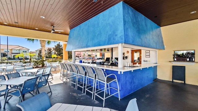 view of patio / terrace featuring a bar and ceiling fan