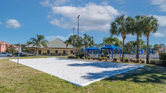 view of home's community with a lawn and volleyball court