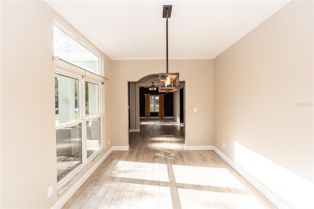 hallway with ornamental molding, a chandelier, and wood-type flooring