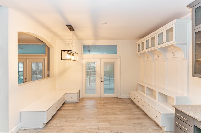 mudroom with french doors and light hardwood / wood-style flooring