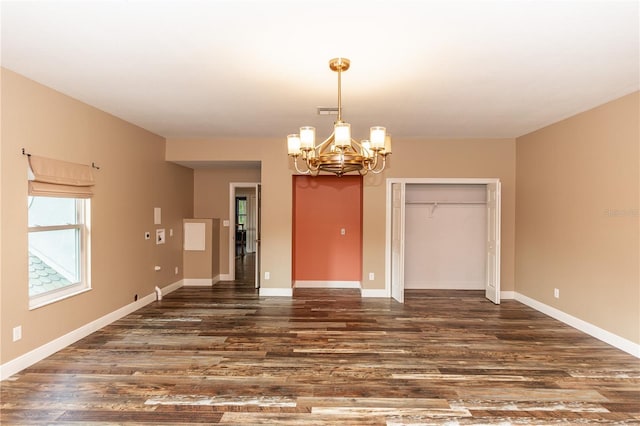 interior space featuring dark wood-type flooring and an inviting chandelier