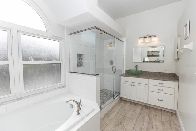 bathroom with vanity, hardwood / wood-style floors, and independent shower and bath