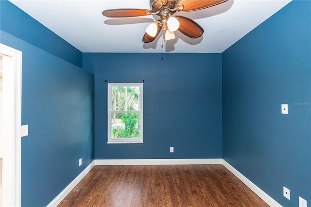 empty room featuring dark hardwood / wood-style flooring and ceiling fan