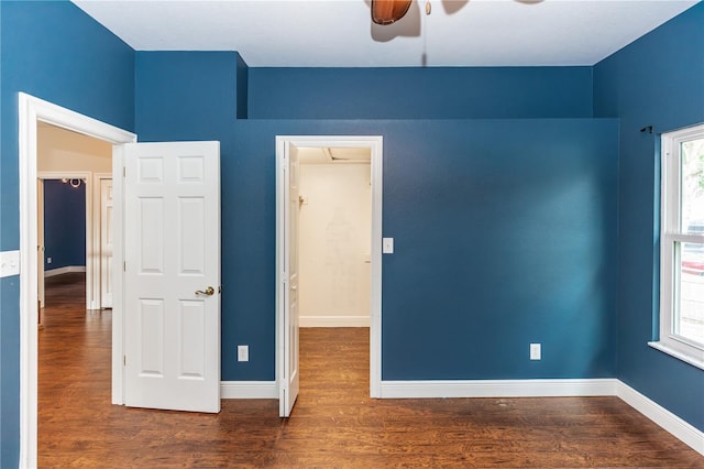 unfurnished bedroom with dark wood-type flooring and ceiling fan