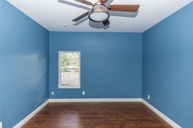 empty room featuring ceiling fan and dark hardwood / wood-style flooring