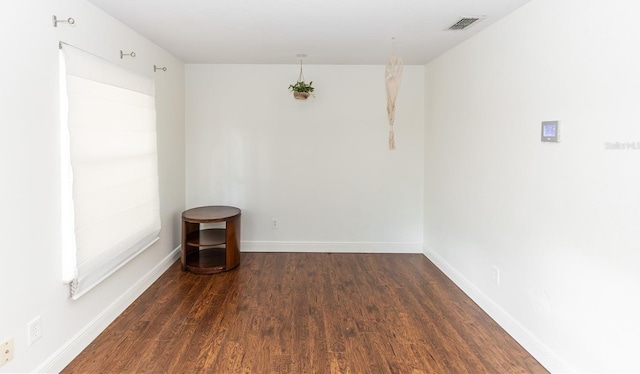 empty room featuring dark hardwood / wood-style flooring