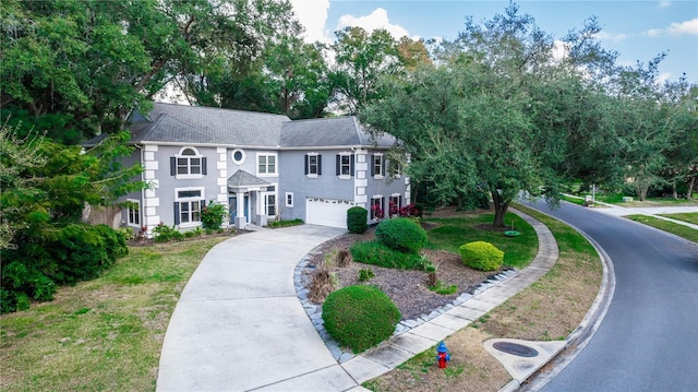 view of front facade featuring a garage and a front lawn